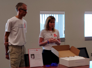 Ron and Jill Plush, Kyle Plush's mom and dad, present cookies to 9-1-1 operators in Pinellas County.